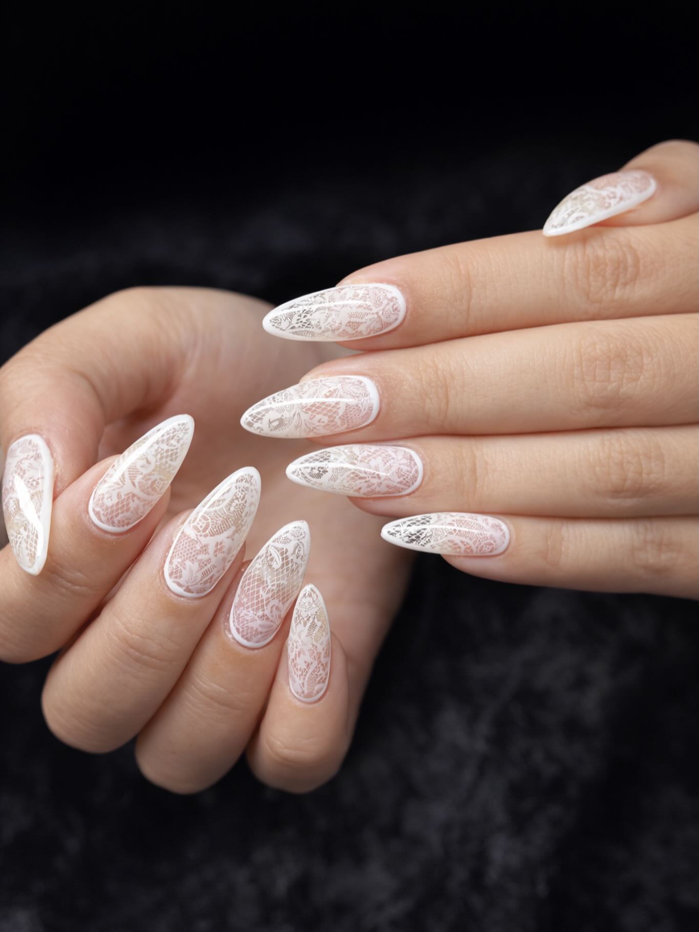 Detailed white lace nail art set photographed on black satin by BeautifulClawz